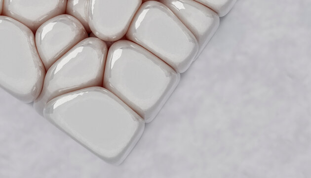 Close-up of smooth, white stone shapes forming a geometric pattern on a textured surface.