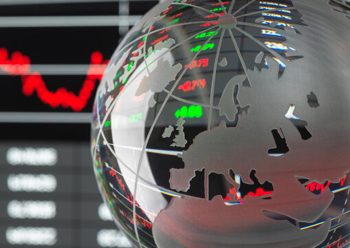 Transparent globe with red and green financial data overlay on a digital stock chart.