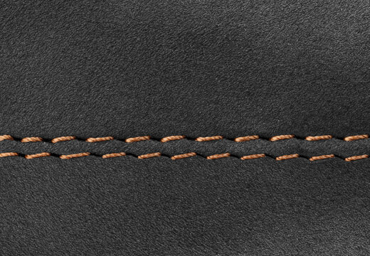 Close-up of Black suede leather texture with double stitching