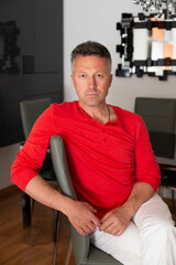 Fototapeta premium Portrait of a man wearing the traditional white-and-red attire of the San Fermín festival in Pamplona. A contemporary lifestyle image celebrating Spanish culture and heritage
