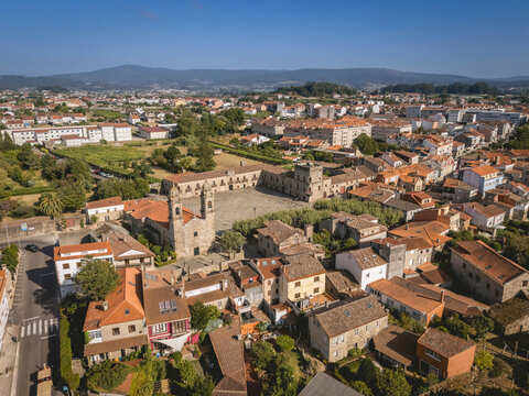 Aerial view of a historic town with rustic buildings and a prominent central square.