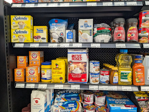 Quebec, Canada, 24 April 2026 : Various grocery products and household staples are displayed on a supermarket shelf in a retail store.