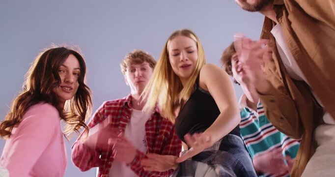 Happy dancing active friends group enjoy listening to favourite track, spending time together moving having fun, modern sporty dance style, dancers social gathering for entertainment, movement fun