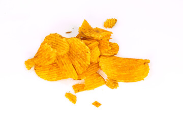 Fototapeta premium A pile of crispy ridged potato chips seasoned with paprika and spices, arranged in a heap, isolated on white background