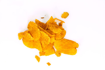 Fototapeta premium A pile of ridged potato chips seasoned with paprika or barbecue flavor, arranged in a casual heap and isolated on white background