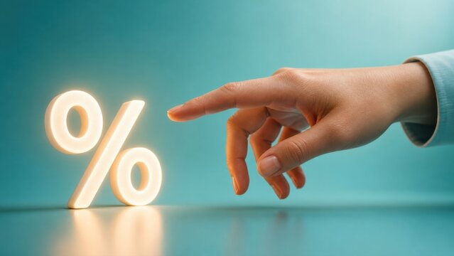 Close up shot of hand pointing at glowing percent symbol represents interest rate review financial investment growth and savings success in high end commercial office environment