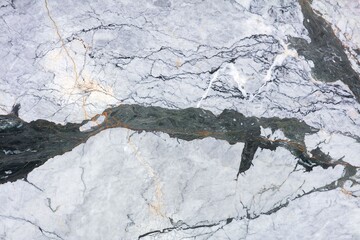 Fototapeta premium Close view of a marble surface showing white, gray, and black patterns with lines and veins
