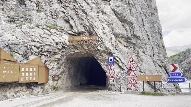 Low Angle of the Kemaliyeli Tas Yolu Stone Road Tunnel Entrance Hand Carved in Rocky Canyon Cliff in Turkey
