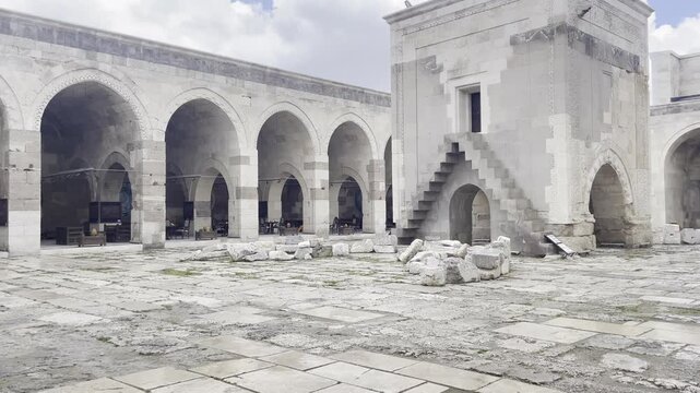 Low Angle Ancient Sultanhani Caravanserai Courtyard Mosque Under Cloudy Drizzle Sky in Aksaray Turkey