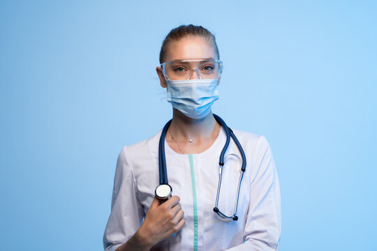 Female doctor wearing mask, goggles, and stethoscope for healthcare protection