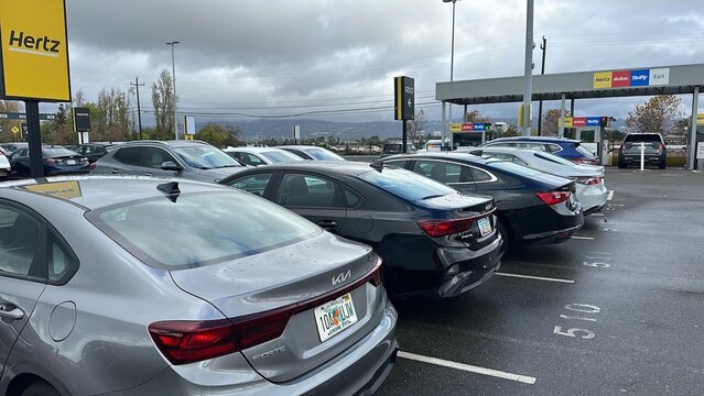 Hertz Rental Parking Lot with Multiple Luxury and Economy Car Brands