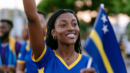 Obraz premium Passionate Young Curaçao Female Football Fan Celebrating at Sunset