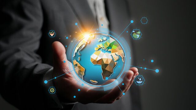 Businessman's hand holding a digital globe with sustainability icons for World Environment Day, representing global ecology awareness, green technology and environmental protection concept