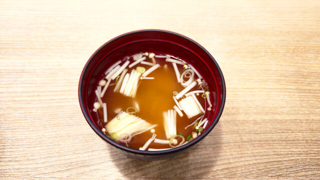 Traditional Japanese clear soup enoki mushrooms green onion served bowl showcasing light healthy comforting cuisine