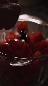 Chopped tomatoes in food processor for traditional Spanish gazpacho preparation. Spanish cuisine and healthy summer food.