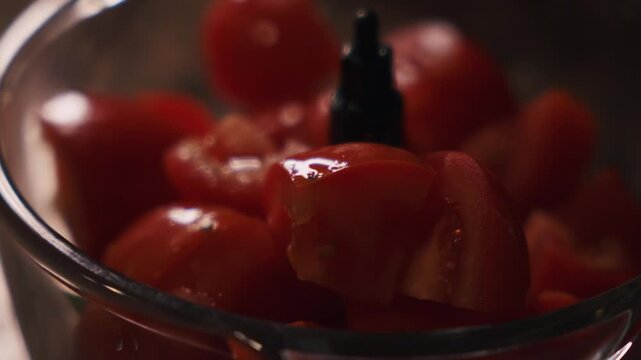 Chopped tomatoes in food processor for traditional Spanish gazpacho preparation. Spanish cuisine and healthy summer food.