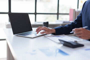 Fototapeta premium Business man analysis summary graph reports of business operating expenses and work data about the company's financial statements.