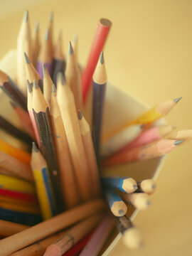 Macro Close-Up of Pencil Tips and Bottoms in White Cup Wooden Table Artist Studio