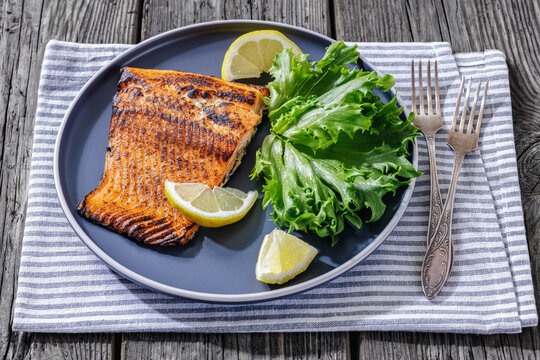 Salmon tikka grilled fish with lemon on plate