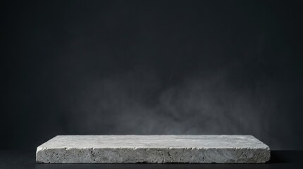 Obraz premium Gray concrete stone podium or display platform on dark background with smoke or fog effect ideal for product photography and advertising