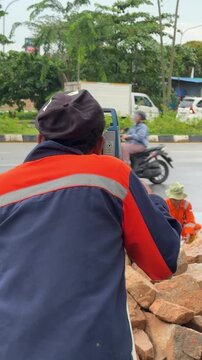 Field technician conducting precise topographical measurements for urban infrastructure advancement