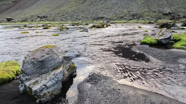 Low Drone Flight Skimming Over Volcanic River Bed and Green Highland Valley in Eldgj&aacute; Iceland