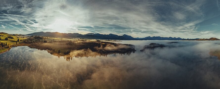 Autumn sunrise in the foothills of the Alps with fog at Illasbergsee and Forggensee near Halblech in Allg&auml;u, Bavaria, Germany