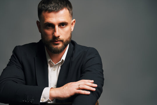 Confident handsome man in black suit