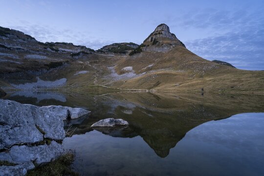 Lake Augstsee and the Atterkogel mountain on the Loser. Autumn, good weather, blue sky. In the evening after sunset. Reflection. Altaussee, Bad Aussee, Ausseer Land, Totes Gebirge, Styria, Upper Austria, Austria