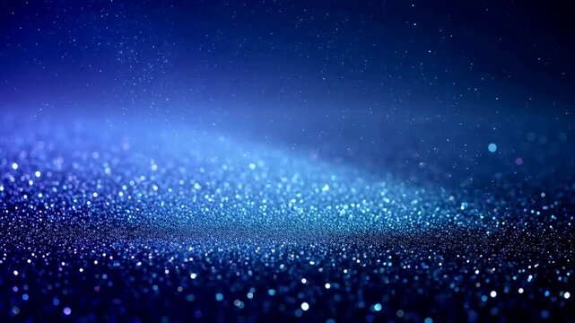 Abstract blue glittering particles on a dark background with soft light effects