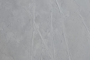 Abstrakcyjne szare tło z wyraźnymi śladami szpachli, minimalistyczna struktura gesso. © Joanna