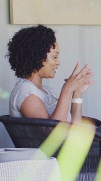 Vertical video: Talking woman gesturing on porch for interview while boom mic extending, copy space