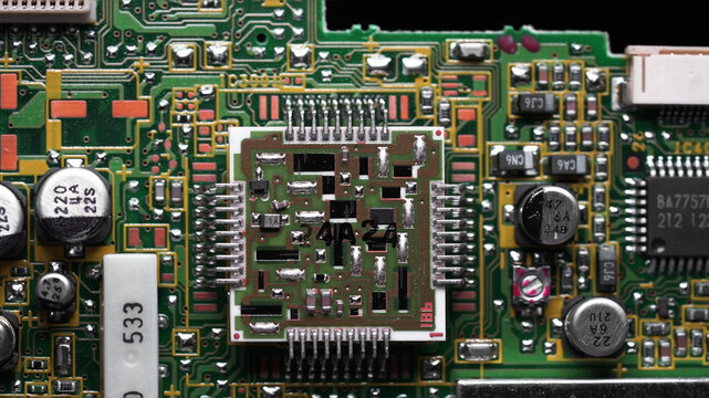 classic green motherboard with chipsets, memory modules, transistors and contacts