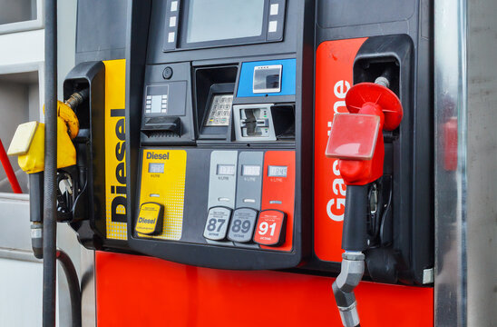 Close-up of a modern gas station fuel pump with gasoline and diesel nozzles.