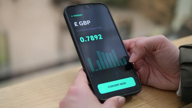 Person analyzing GBP exchange rate trends via a dark-mode chart on a smartphone. Finger interacting with a clean financial dashboard. Ideal for forex news, stock market analytics, and data