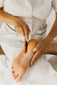 Close up of special foot massage therapy session. Female massage therapist's hands.