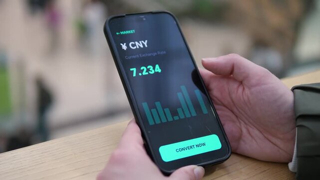 User viewing the Yuan exchange rate on a sleek dark mode app. Convert Now call to action highlighted. Great for money transfer services, travel finance, and fintech UI design content.