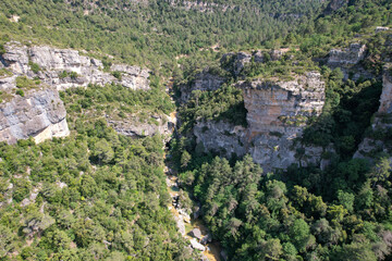 Fototapeta premium Aerial view of La Febró Gorge and La Gorguina waterfall and natural pools on sunny summer day. Tarragona, Spain.