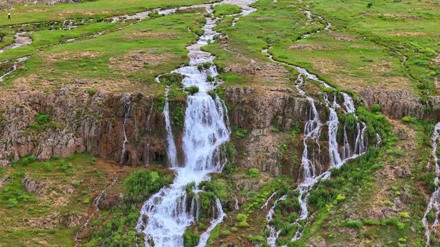 Beautiful mountain stream and multi-tiered Konarli Waterfall in green nature of Erzincan