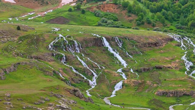 High angle aerial view of Konarli Waterfall system and green highlands in Tercan, Erzincan Turkey