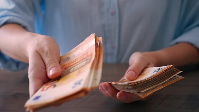 Close up of woman hands counting euro banknotes at desk,cash and managing money during financial planning and accounting process in office environment.Money management, cash handling, finance concept