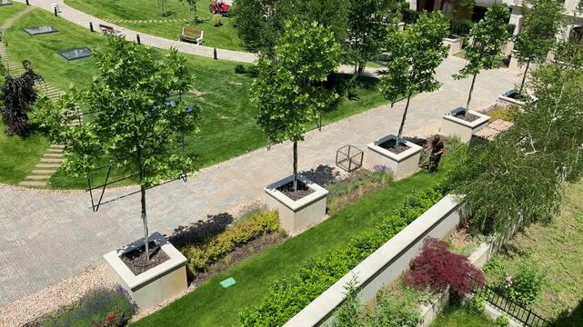 Series of 4 Videos Premium Residential Complex Landscaping Maintenance with Lawn Mowers on Sunny Summer Day