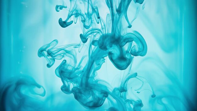 Blue ink swirling underwater creating abstract fluid shapes and artistic patterns in clear water