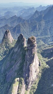 Drone video of Dedo de Deus rock tower with diffused natural light casting soft shadows on the granite.