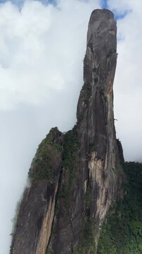 Aerial footage of clouds drifting past the Dedo de Deus rock formation in Rio de Janeiro state.