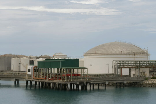 specialized waterfront firefighting facility equipped with red piping manifolds and systems designed for fire hazard mitigation and emergency response at a maritime industrial terminal