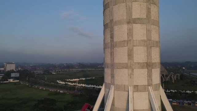 Aerial view of Menara Pandang Teratai tower with its unique architecture and surrounding landscape in Kecamatan Purwokerto Timur, Jawa Tengah, Indonesia.