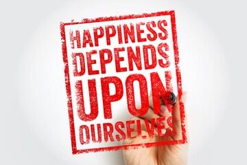 Obraz premium HAPPINESS DEPENDS UPON OURSELVES stamp text held by a hand. Empowering psychological quote about self-reliance, emotional well-being, and taking responsibility for one's own joy and life path