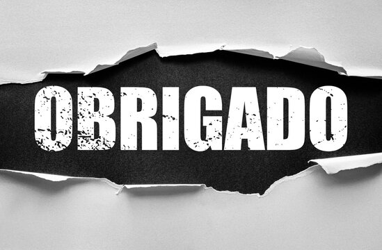 Torn paper design reveals bold distressed Portuguese word OBRIGADO meaning thank you. A striking typographic artwork expressing gratitude, appreciation, and acknowledgment in creative style