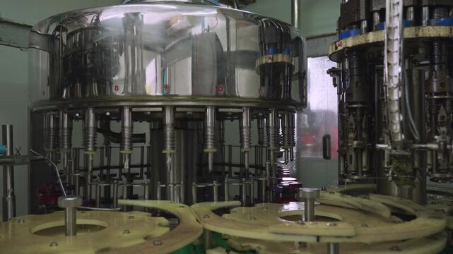 Automated machinery in the food and drink industry. Warming up machinery before production. Machine used in beverage production lines. Empty modern conveyor belt in bottling manufacturing industrial. 